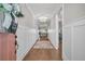 Bright hallway with hardwood floors and white wainscoting leading to the living room at 139 Calm Water Way, Summerville, SC 29486