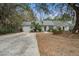 Charming home with well-maintained lawn, mature trees and a driveway leading to the attached garage at 1570 Brianna Ln, Charleston, SC 29412