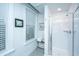 Bright bathroom featuring a glass shower, white subway tile, and window with white blinds at 1641 Florentia St, Mount Pleasant, SC 29464