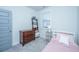 A cozy bedroom features a dresser, a side table, and a large window with blinds at 1641 Florentia St, Mount Pleasant, SC 29464