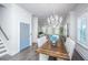 Charming dining area with a rustic table, chandelier, and ample natural light, ideal for Gathering gatherings at 1641 Florentia St, Mount Pleasant, SC 29464