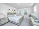 A serene main bedroom features neutral tones, two windows, and coordinated furnishings for a relaxing retreat at 1641 Florentia St, Mount Pleasant, SC 29464