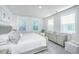 A serene main bedroom features neutral tones, two windows, and coordinated furnishings for a relaxing retreat at 1641 Florentia St, Mount Pleasant, SC 29464