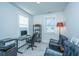 Comfortable home office with a glass desk, rolling chair, and sitting area at 1641 Florentia St, Mount Pleasant, SC 29464