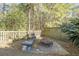 Backyard sitting area with a firepit, wooden fence, and established foliage at 1738 Towne St, Johns Island, SC 29455