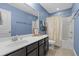 Well-lit bathroom with a large mirror, vanity with ample storage, and a shower with patterned curtain at 1738 Towne St, Johns Island, SC 29455