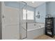 Bright bathroom features a large soaking tub and a separate shower with blue walls and a decorative cabinet at 1738 Towne St, Johns Island, SC 29455