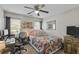 Bright bedroom with a desk, chair, a floral quilt bed, and a window with a wooded view at 1738 Towne St, Johns Island, SC 29455