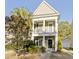 Charming two-story home with front porch, white pillars, and manicured landscaping at 1738 Towne St, Johns Island, SC 29455