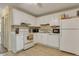 Bright kitchen with white cabinets, modern appliances, light backsplash, and vinyl floors, complemented by natural light at 1910 Tropicana Rd # 9-D, North Charleston, SC 29406