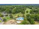 Aerial view of a community pool and golf course nestled among mature trees at 195 Droos Way, Charleston, SC 29414