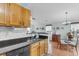 Well-lit kitchen featuring granite countertops, stainless steel appliances, and a pass-through window to the dining area at 195 Droos Way, Charleston, SC 29414