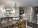 Cozy dining area with a rustic wooden table set, modern lighting, and stylish decor for a welcoming atmosphere at 203 Pine Crest View Dr, Summerville, SC 29486