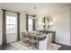 Elegant dining room featuring a wooden table, stylish chandelier, and a decorative mirror creating a warm ambiance at 203 Pine Crest View Dr, Summerville, SC 29486