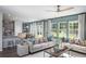 Bright living room with large windows, two sofas, stylish decor, and an open view to the dining area at 203 Pine Crest View Dr, Summerville, SC 29486