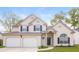Charming two-story home featuring a two-car garage, manicured lawn, and inviting front porch at 204 Candleberry Cir, Goose Creek, SC 29445
