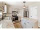 Modern kitchen with stainless steel appliances, granite countertops, and stylish gray cabinetry at 204 Candleberry Cir, Goose Creek, SC 29445