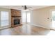 Spacious living room featuring beautiful floors, a charming brick fireplace, and natural light at 204 Candleberry Cir, Goose Creek, SC 29445
