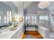 Bathroom featuring double sinks with a marble countertop, hardwood floors, and a glass shower at 204 Live Oak Dr, Mount Pleasant, SC 29464