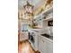 Bright laundry room features shelving, sink, front load washer and dryer, and hardwood flooring at 204 Live Oak Dr, Mount Pleasant, SC 29464