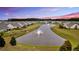 Aerial view of homes surrounding a pond with fountains at 205 Potters Pass Dr, Summerville, SC 29486