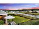 Spacious backyard with a patio, screened porch and a view of the community pond at 205 Potters Pass Dr, Summerville, SC 29486