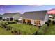 Well-manicured backyard featuring a patio, plush lawn, and screened porch at 205 Potters Pass Dr, Summerville, SC 29486