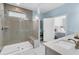 Updated bathroom features a tiled walk-in shower with a built-in seat and a view into the bedroom at 205 Potters Pass Dr, Summerville, SC 29486