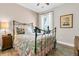 Bedroom features a ceiling fan, hardwood floors, and a large window for natural light at 205 Potters Pass Dr, Summerville, SC 29486