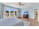 A serene bedroom with large windows, a ceiling fan, hardwood floors, and view of a fountain at 205 Potters Pass Dr, Summerville, SC 29486