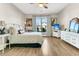 Bright bedroom with a ceiling fan, hardwood floors, large window, and view of the surrounding neighborhood at 205 Potters Pass Dr, Summerville, SC 29486