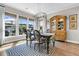 A dining room with large windows, natural light, a china cabinet, and a blue and white rug at 205 Potters Pass Dr, Summerville, SC 29486