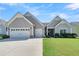 Beautifully landscaped home featuring a lush lawn, a convenient two-car garage and inviting curb appeal at 205 Potters Pass Dr, Summerville, SC 29486