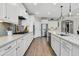 A stylish kitchen with white cabinetry, stainless steel appliances, and wood flooring at 205 Potters Pass Dr, Summerville, SC 29486