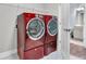 Bright laundry room featuring a front load washer and dryer set, with a door leading to a bathroom at 205 Potters Pass Dr, Summerville, SC 29486