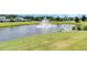Scenic view of a pond with a fountain feature, enhancing the beauty of this landscaped neighborhood at 205 Potters Pass Dr, Summerville, SC 29486