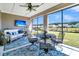 This screened porch offers a peaceful retreat, complete with a TV for relaxation and backyard views at 205 Potters Pass Dr, Summerville, SC 29486