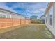 A fully fenced in backyard featuring a healthy lawn and a view of the neighborhood at 219 Clearblue Loop, Summerville, SC 29486