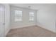 Sun-filled bedroom with neutral carpet, two windows, and a crisp, bright atmosphere at 219 Clearblue Loop, Summerville, SC 29486
