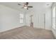 Bedroom with carpet floors, a ceiling fan, windows, and a view into the bathroom at 219 Clearblue Loop, Summerville, SC 29486