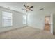 Bedroom with carpet floors, a ceiling fan, windows, and a doorway to the hallway at 219 Clearblue Loop, Summerville, SC 29486