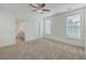 Bedroom with carpet floors, a ceiling fan, windows, and a view into the bathroom at 219 Clearblue Loop, Summerville, SC 29486