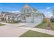 Exterior of home with attached garages, manicured lawn, professional landscaping and close proximity to neighbors at 219 Clearblue Loop, Summerville, SC 29486