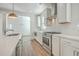 Bright kitchen featuring stainless steel appliances, wooden floors, white cabinetry and countertops at 219 Clearblue Loop, Summerville, SC 29486
