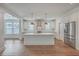 Modern kitchen with white cabinets, stainless appliances, an island, and trendy pendant lighting at 219 Clearblue Loop, Summerville, SC 29486
