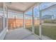 View of screened-in patio with concrete floor overlooking fenced backyard and neighborhood at 219 Clearblue Loop, Summerville, SC 29486