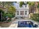 Charming backyard featuring a grill, patio dining set, and a refreshing in-ground swimming pool at 23 Elliott St, Charleston, SC 29401