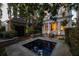 Private backyard with a charming water feature, outdoor dining and seating area at 23 Elliott St, Charleston, SC 29401