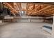 Spacious unfinished basement with exposed ceiling beams and concrete floor at 23 Elliott St, Charleston, SC 29401