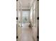 Elegant bathroom featuring a freestanding soaking tub with open French doors at 23 Elliott St, Charleston, SC 29401